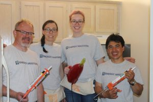 Smiling Energy Masters Volunteers holding tools