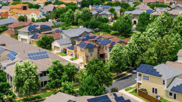 neighborhood shot from overhead with buildings, houses, roads and trees.