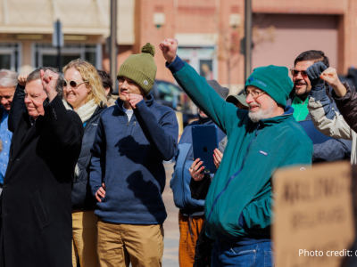 2025-Climate Resolution-6 The crowd at the rally on 2/22/2025 holding up their fists and cheering. Photo credit: @elmanstudio