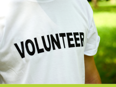 Photo closeup of white t-shirt with volunteer written across it