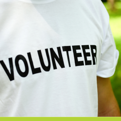 Photo closeup of white t-shirt with volunteer written across it