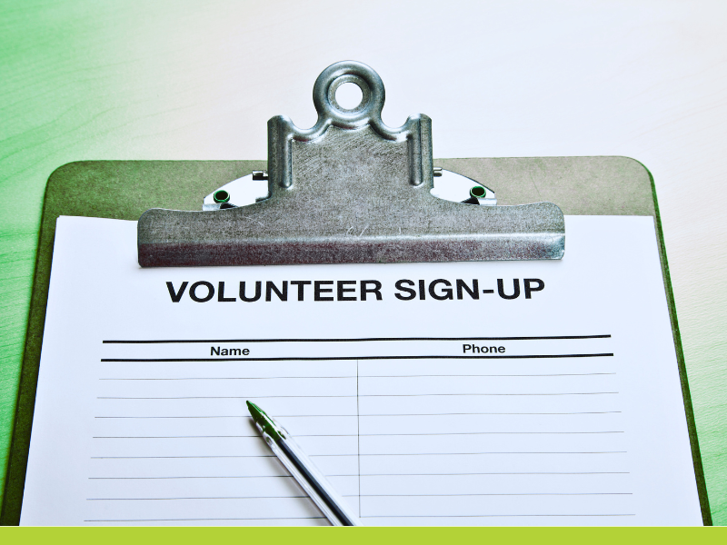 photo of a clipboard with a sheet of paper with the header Volunteer Signup