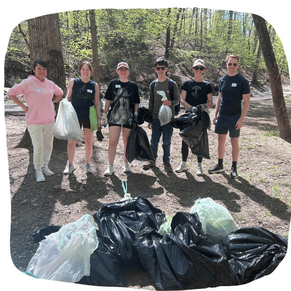 Earth Day Cleanup 2026 volunteer group posing in front of trash bags at Lubber Run Park