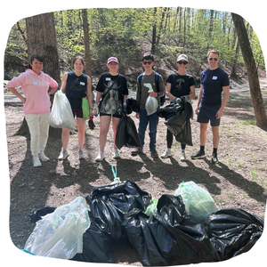 Earth Day Cleanup 2026 volunteer group posing in front of trash bags at Lubber Run Park