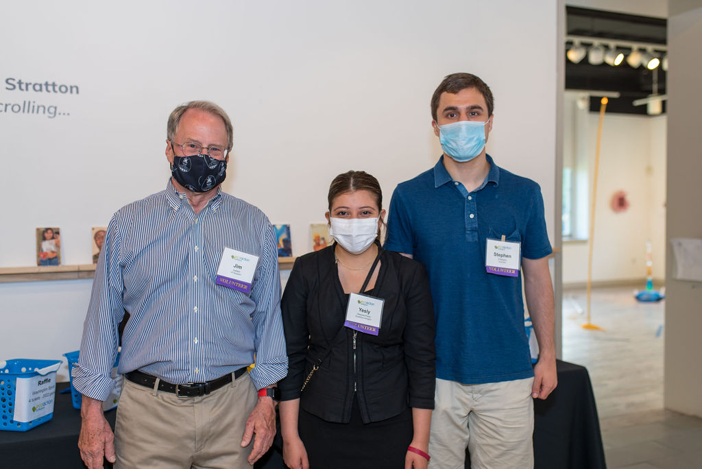 three people posing wearing masks and name tags